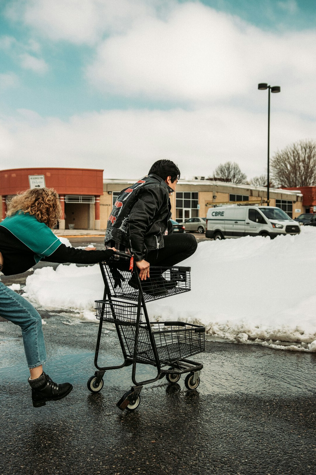 man pushing shopping cart