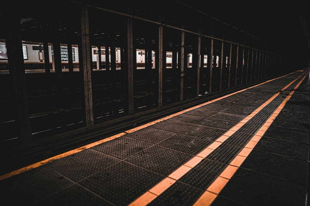 Empty train platform at night with soft lighting